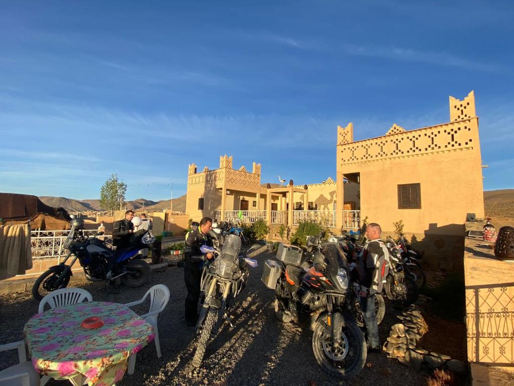 a group of motorcycles parked in front of a house at Auberge Agoudal in Agoudal