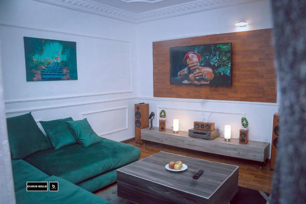 a living room with a green couch and a table at CloudHill in Buea
