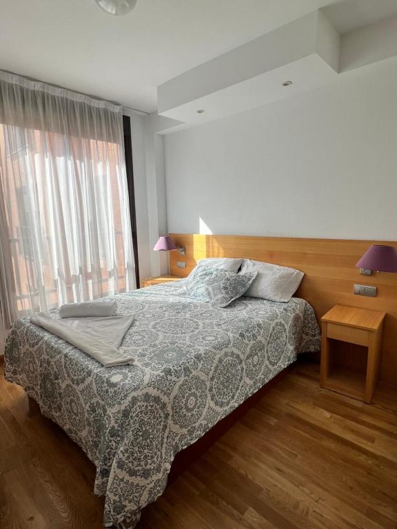 a bedroom with a bed and a large window at Samaniego suite, AirPort, ifema turístico in Madrid