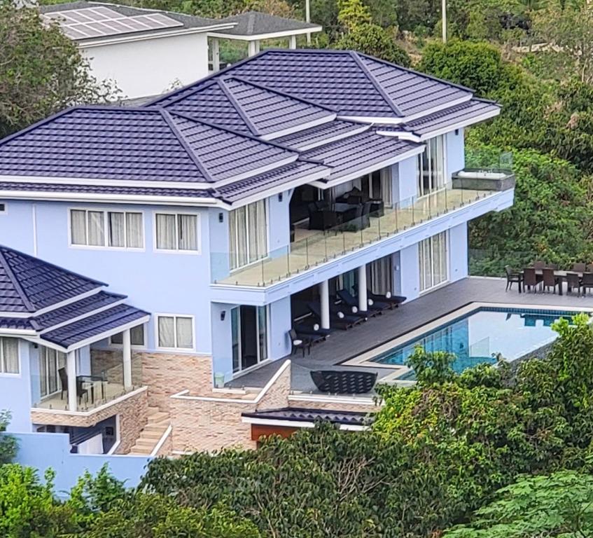 a house with solar panels on its roof at IslandView Villa in Choeng Mon Beach