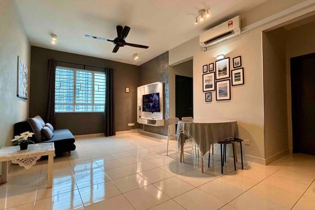 a living room with a table and a ceiling fan at Moderm Spacious 6pax S PICE Penang in Bayan Lepas