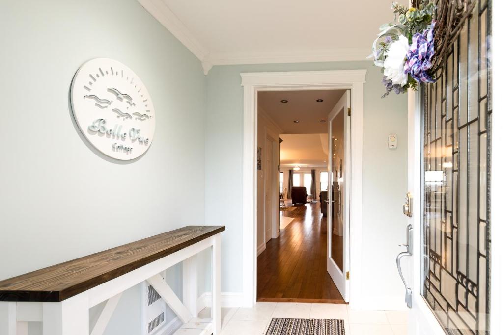 a hallway with a wooden bench in a house at Belle Vue Cottage - Upper Island Cove in Upper Island Cove