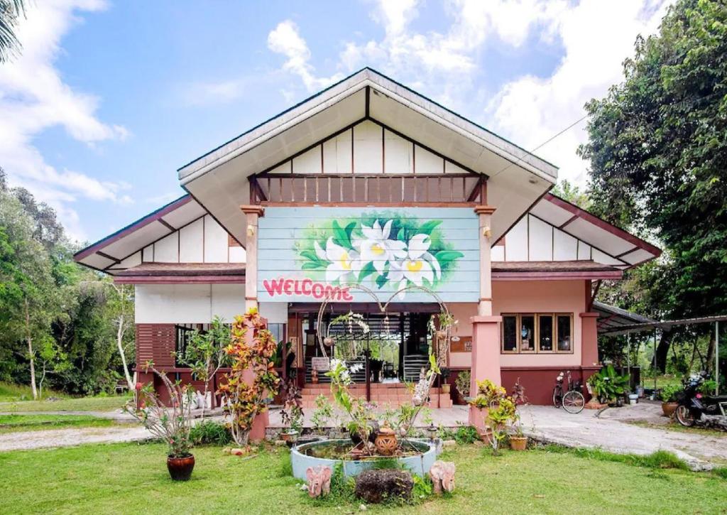 a building with a flower mural on the side of it at Waterjade Resort in Phangnga