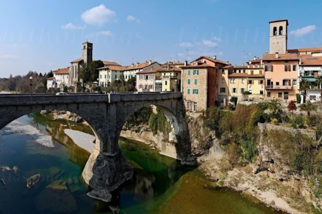 a bridge over a river with buildings in the background at Casa Marlò Centro Storico in Cividale del Friuli