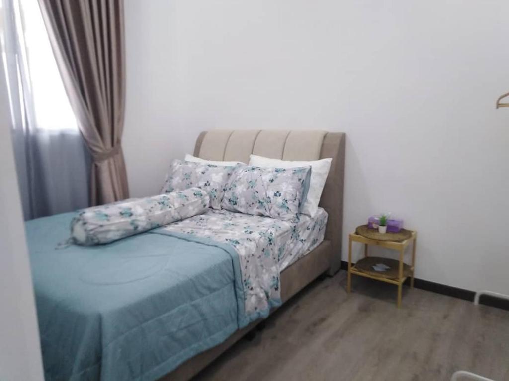 a bedroom with a bed with a couch and a table at Sakinah Homestay P5 Putrajaya in Putrajaya