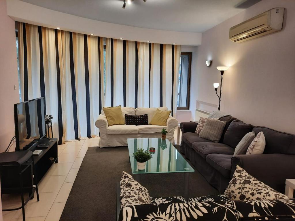 a living room with a couch and a tv at 3 Bedroom Apartment in Nicosia
