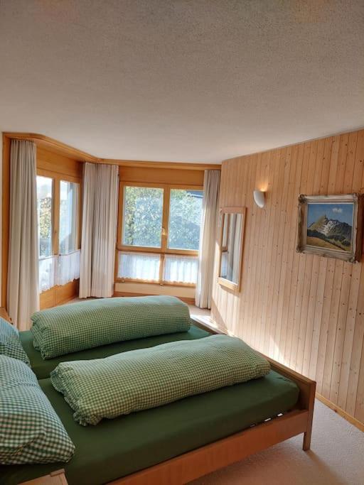 a bedroom with two green pillows on a bed at Charmante Wohnung im Dorfkern in Klosters