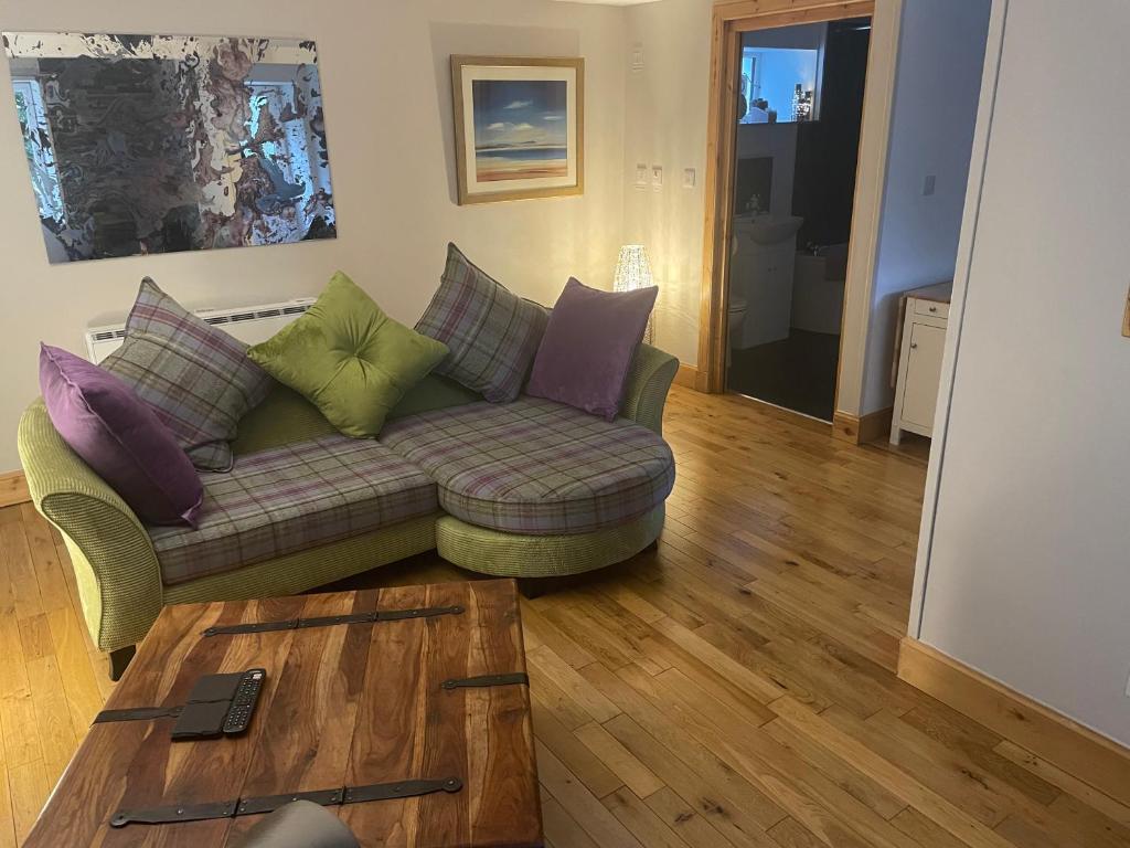 a living room with a couch and a table at The Mews 2 bedroom with private parking in Oban