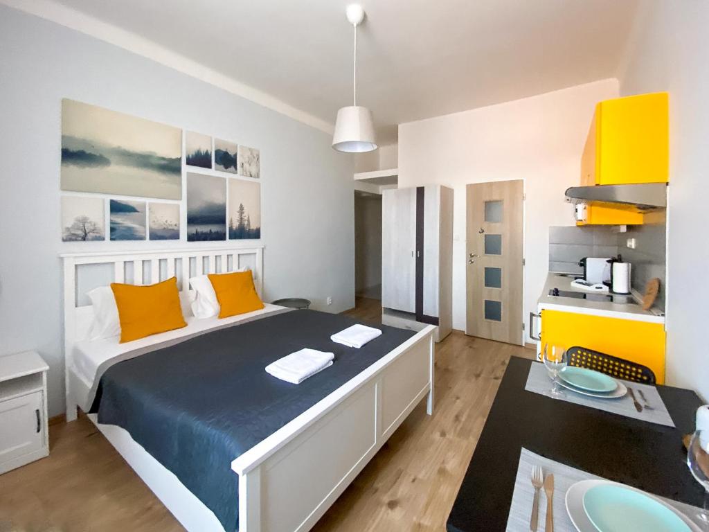 a bedroom with a bed and a desk in it at ELSO apartments in Prague