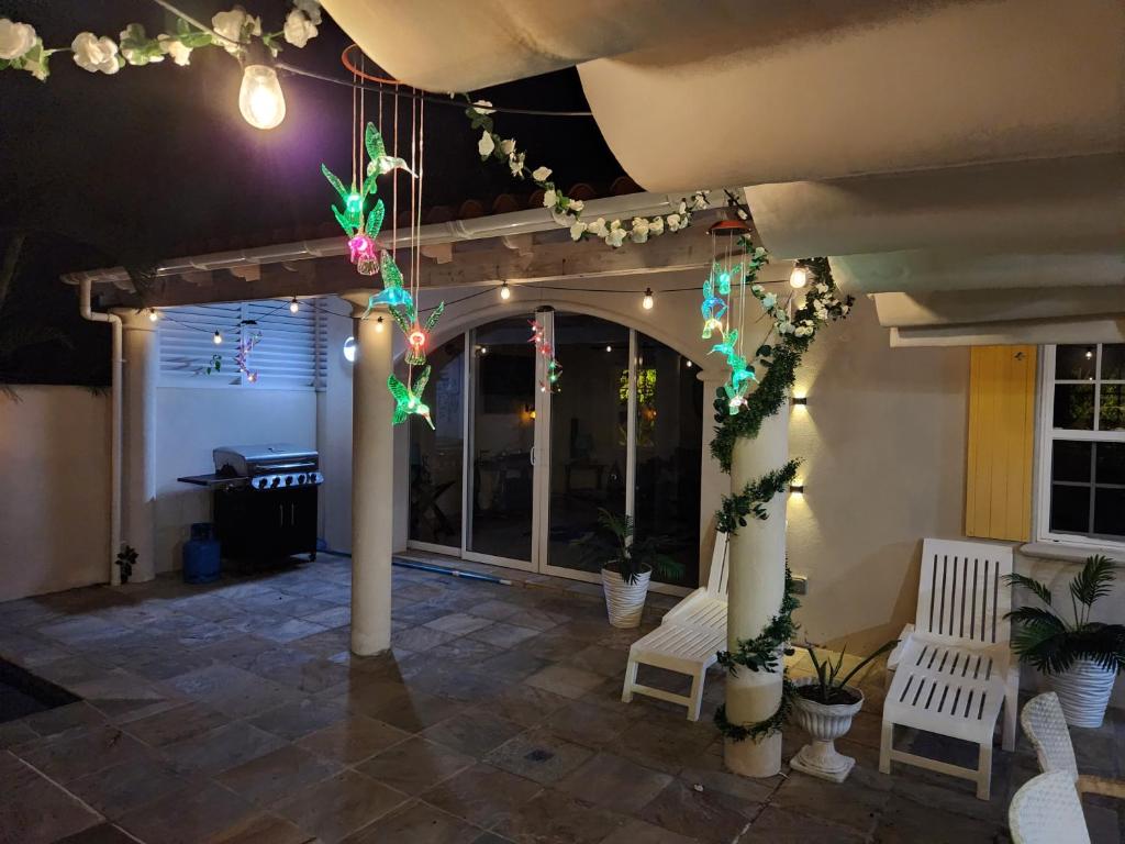 a patio with christmas lights on the ceiling at Sweet Home Grenada Caribbean in Lance aux Épines