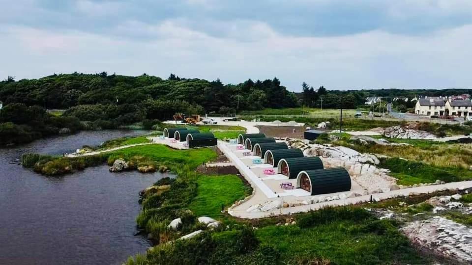 an aerial view of a house by a river at Wheelhousepods glamping in Donegal