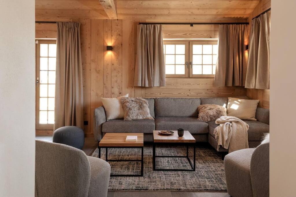a living room with a couch and a table at Appartement Rémy - at the foot of the slopes in Saint-Gervais-les-Bains