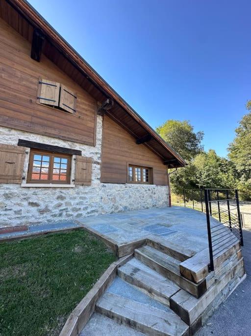 a house with stairs in front of a building at Appartement Rémy - at the foot of the slopes in Saint-Gervais-les-Bains