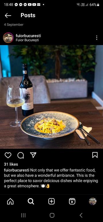 a website with a plate of food and a bottle of wine at Private room at Ceausescu's place in Old City Unirii Square in Bucharest
