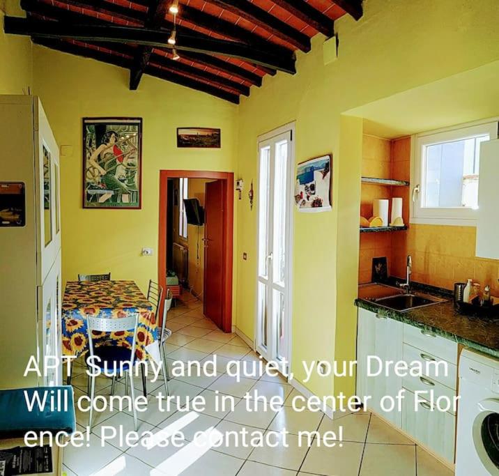 a room with a kitchen with a table and a counter top at Apt bright, quiet! In the center. in Florence