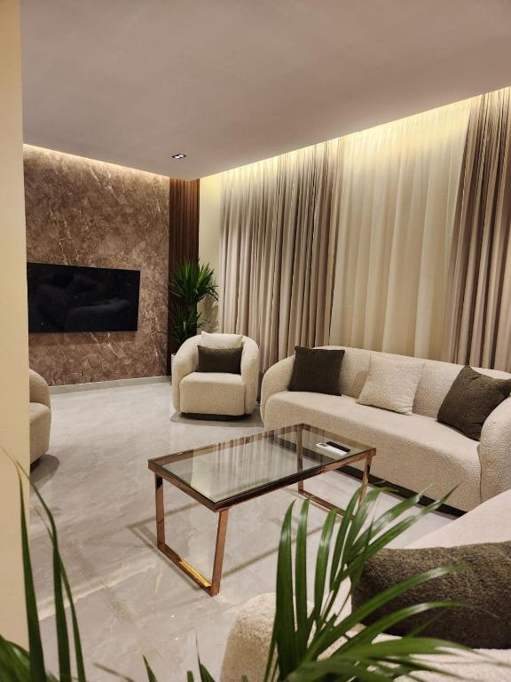 Sala de estar con 2 sofás y mesa de centro en رهف ريزيدنس Rahaf smart residence, en Riad