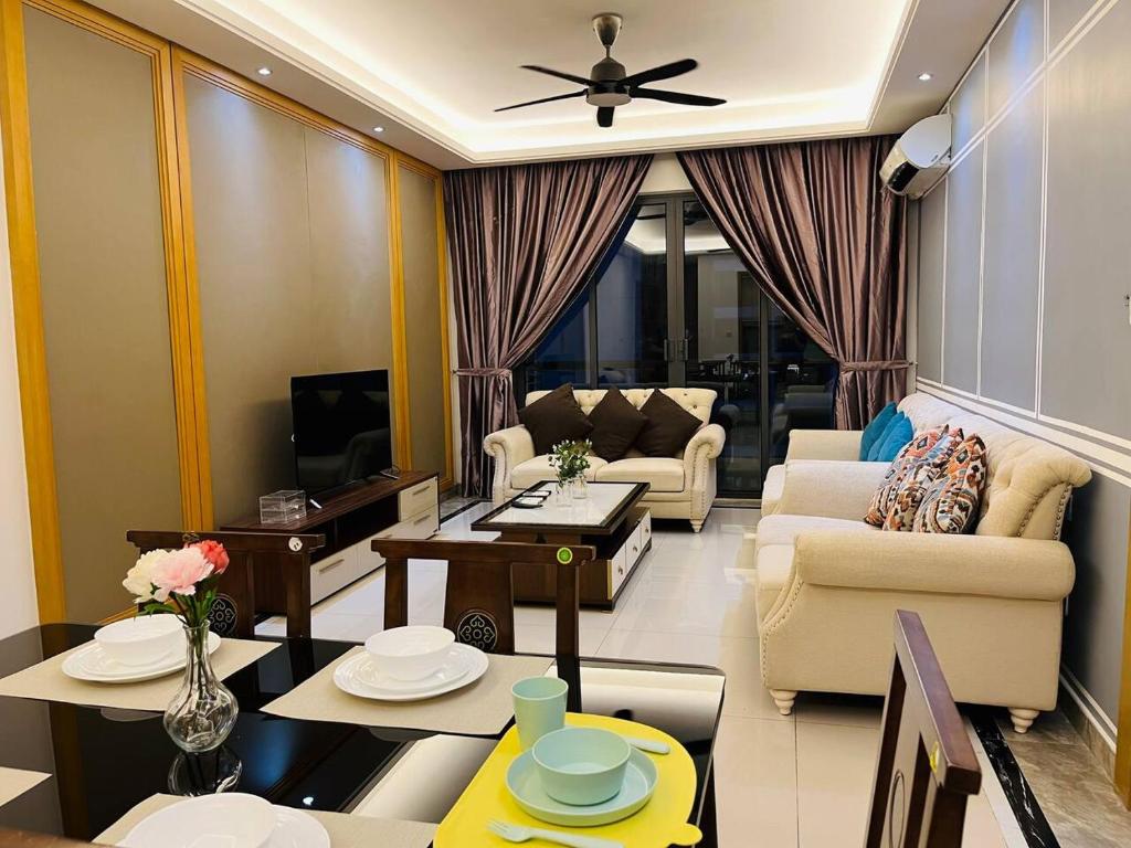 a living room with a couch and a tv at Pleasant and Cozy 3BR Suit @ R&F Mall Johor Bahru in Johor Bahru
