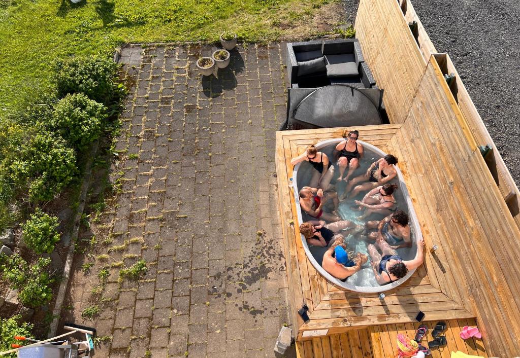 an overhead view of people in a hot tub at Mengi Countryside in Kjarnholt