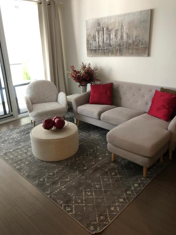 a living room with a couch and two chairs and a table at Sanctuary in Toronto's centre in Toronto