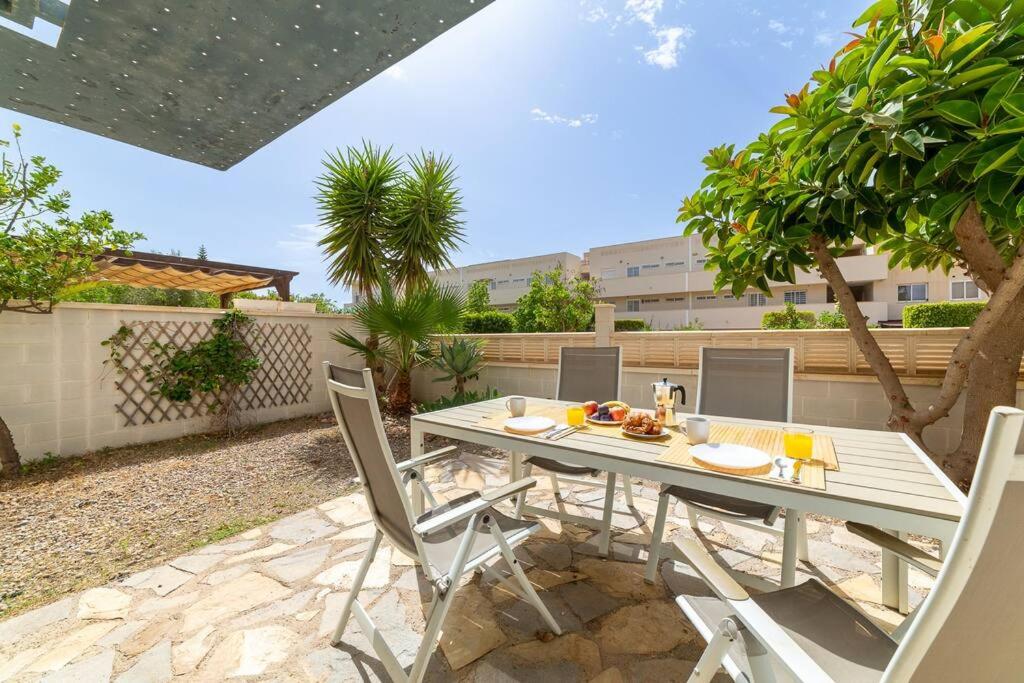 a patio with a white table and chairs at Trendy Homes Toyo Golf in Almería