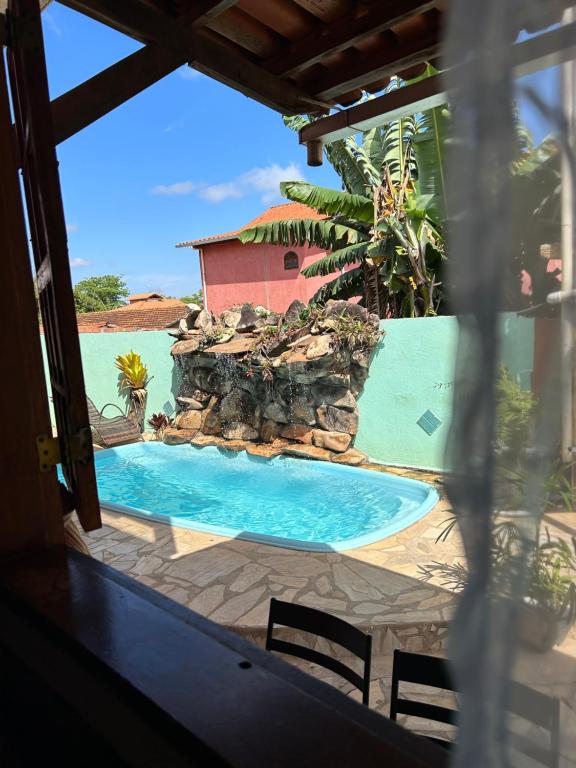 a view of a swimming pool from the porch of a house at Pousada Núcleo da Serra in Serra do Cipo