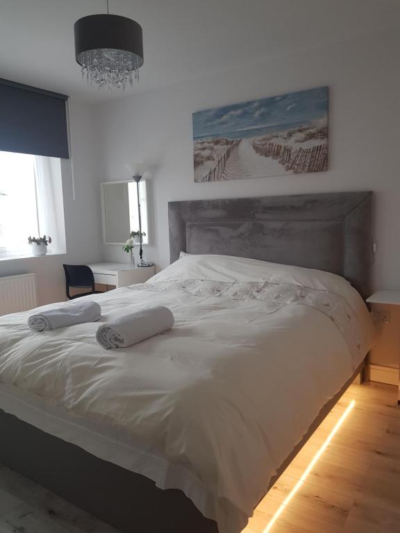 ein großes weißes Bett mit zwei Kissen darauf in der Unterkunft Barnoaks House - New Private Room with Private Bathroom in Dublin