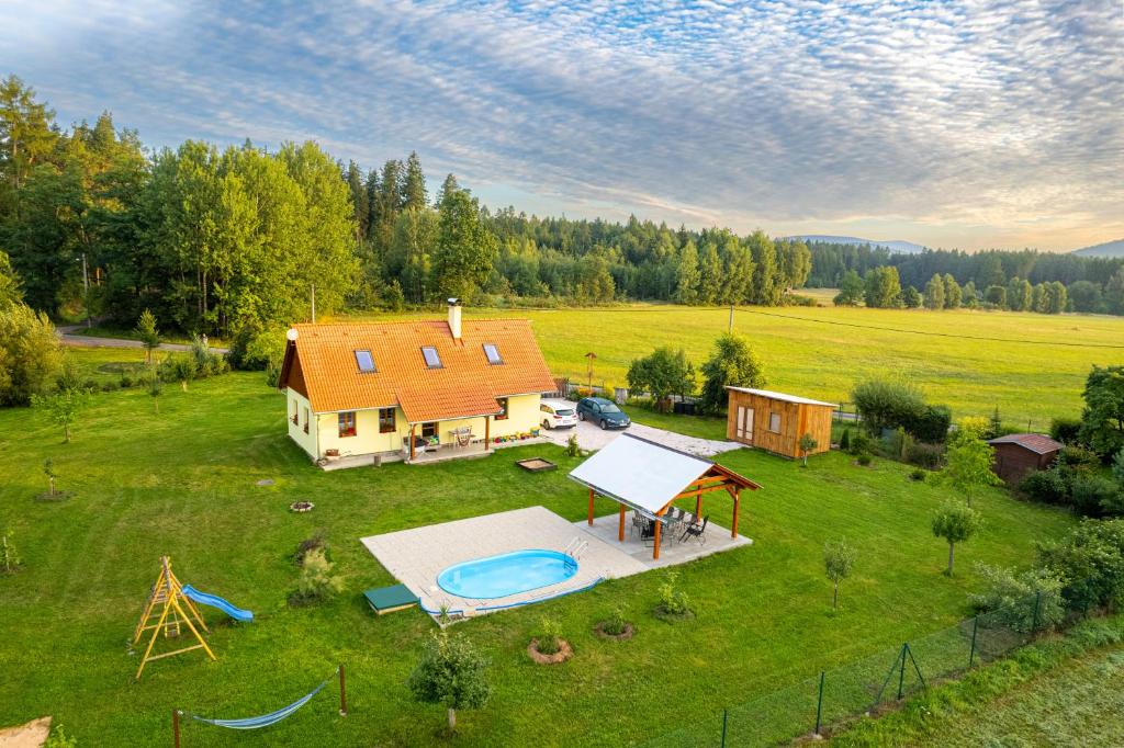 an aerial view of a house with a swimming pool at Chalupa Les Království 