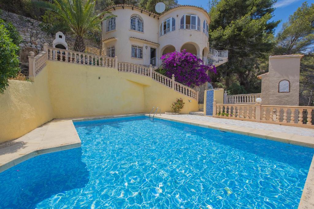 a house with a swimming pool in front of a house at Casa Maryvilla 46 in La Canuta