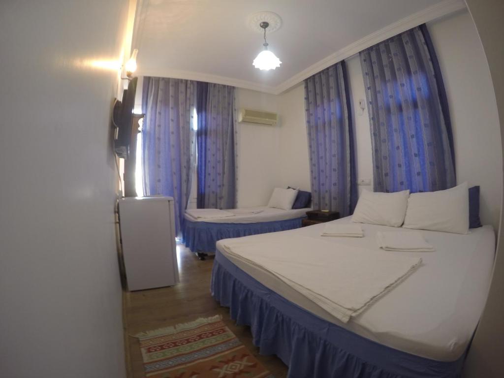 Postel nebo postele na pokoji v ubytování Akkin Pansiyon
