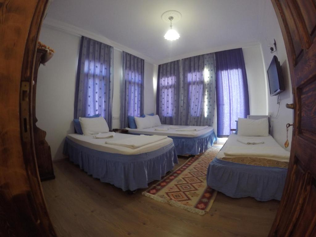 Postel nebo postele na pokoji v ubytování Akkin Pansiyon