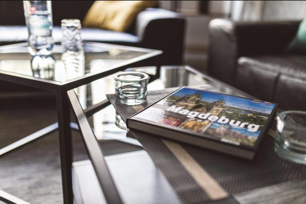 a coffee table with a magazine on top of it at Ottostadt in Magdeburg