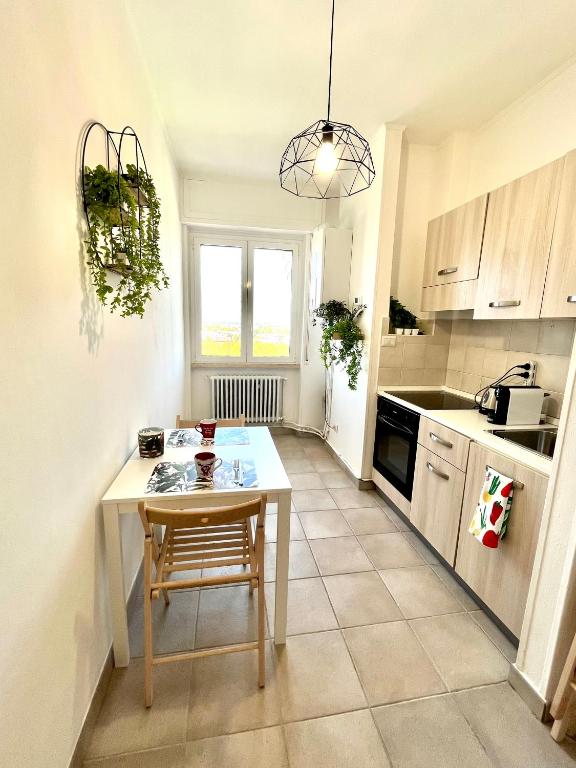 a kitchen with a small table and a table and a kitchen at Skyscraper 11 in Cinisello Balsamo
