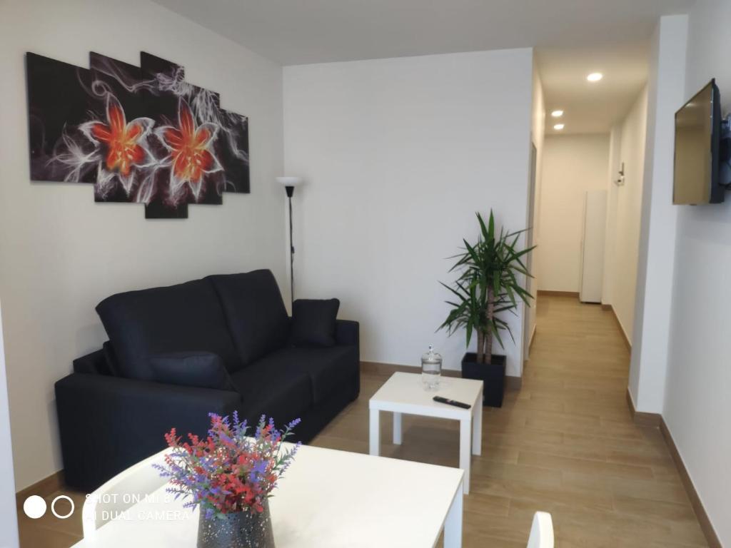 sala de estar con sofá y mesa en Apartamentos Silgar Plaza, en Sanxenxo