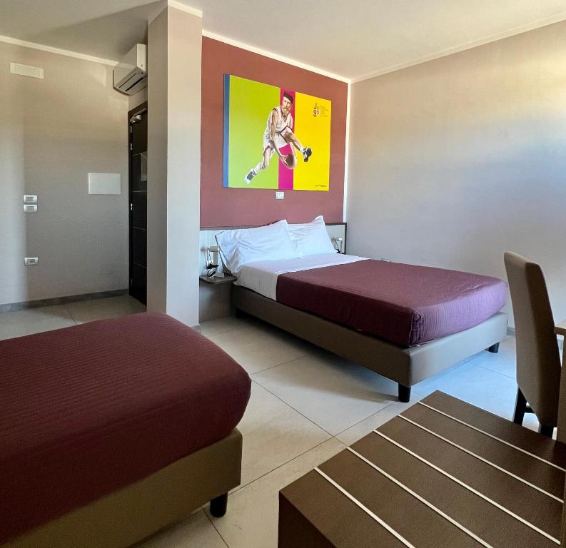 Postel nebo postele na pokoji v ubytování Jogo Rooms