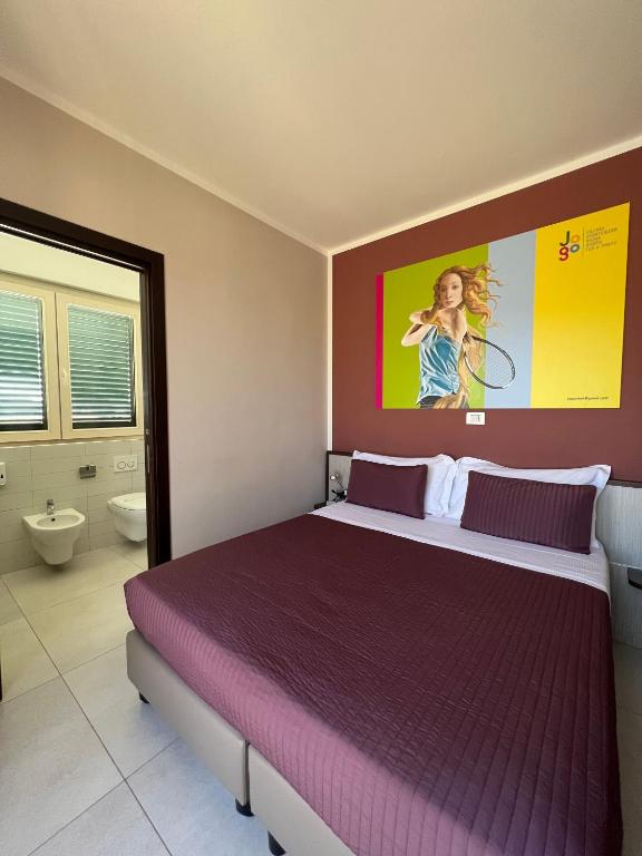 Postel nebo postele na pokoji v ubytování Jogo Rooms