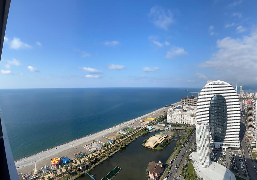 an aerial view of a city and the ocean at Orbi floor40 in Batumi