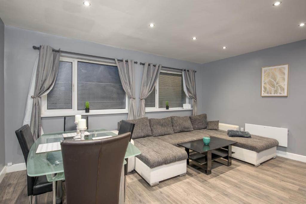 a living room with a couch and a table at SEASIDE SPACIOUS apartment in Peterlee
