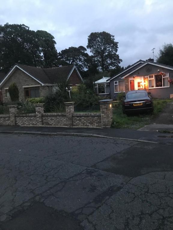 a house with a car parked in front of a driveway at Stonyhurst in Chorley