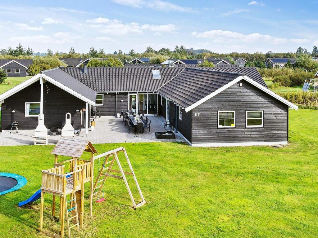 una casa con parque infantil en el patio en 24 person holiday home in Idestrup, en Bøtø By