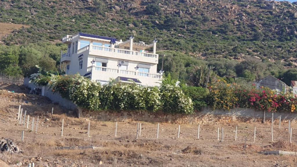 a large white house on the side of a hill at Villa Begdour à 30Mints de Tanger in Tangier