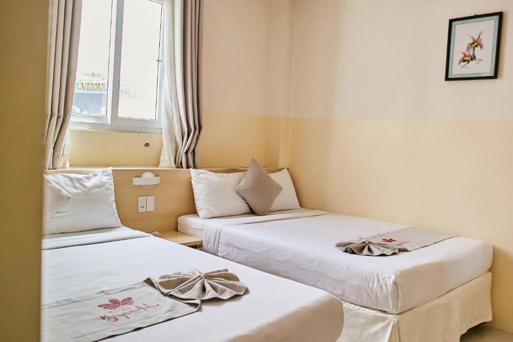 Postel nebo postele na pokoji v ubytování Ngoc Nguyen Anh Da Lat
