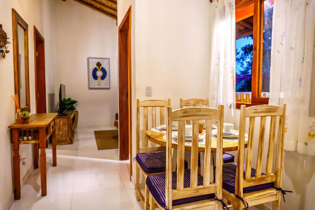 a dining room with a table and chairs at Pousada Casa Joana Trancoso in Trancoso