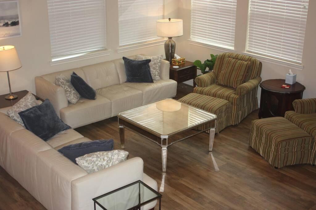 a living room with couches and chairs and a table at 4 Bedroom - Luxury Home and Bedding -Sleeps 9 in Humble
