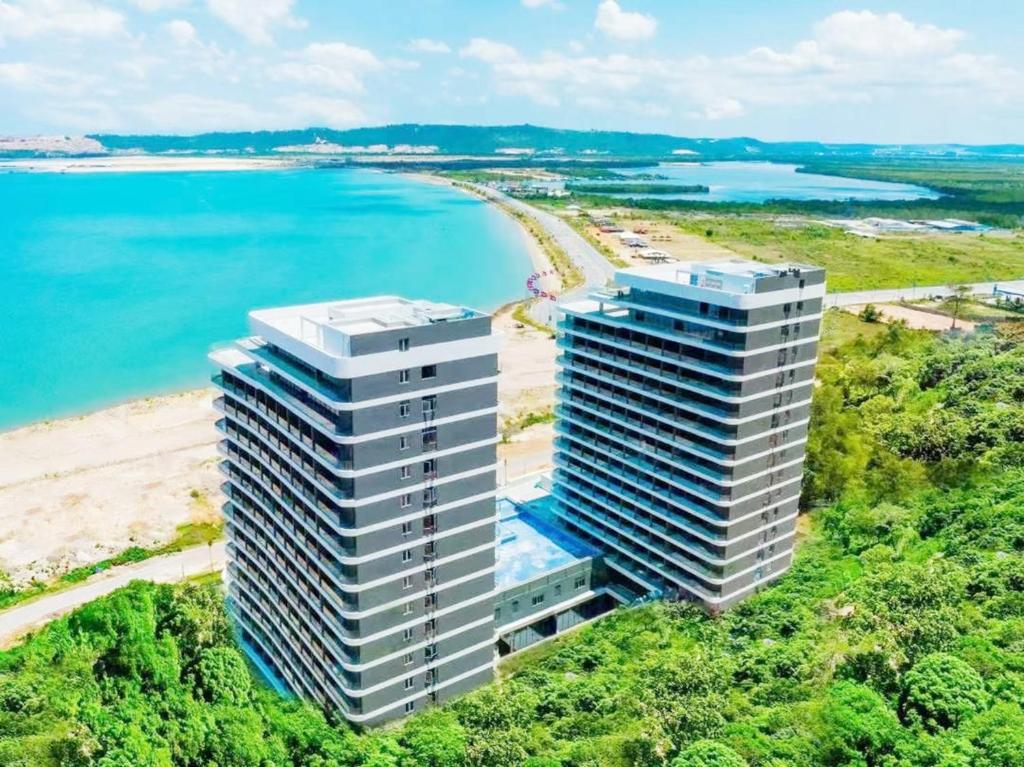 an aerial view of a building next to a beach at Platinum Coast Hotel and condominium 