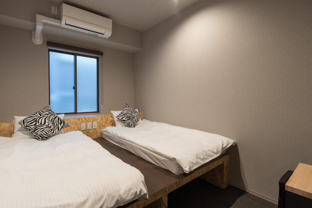 Postel nebo postele na pokoji v ubytování 3U NAMBA MINAMI by DOYANEN