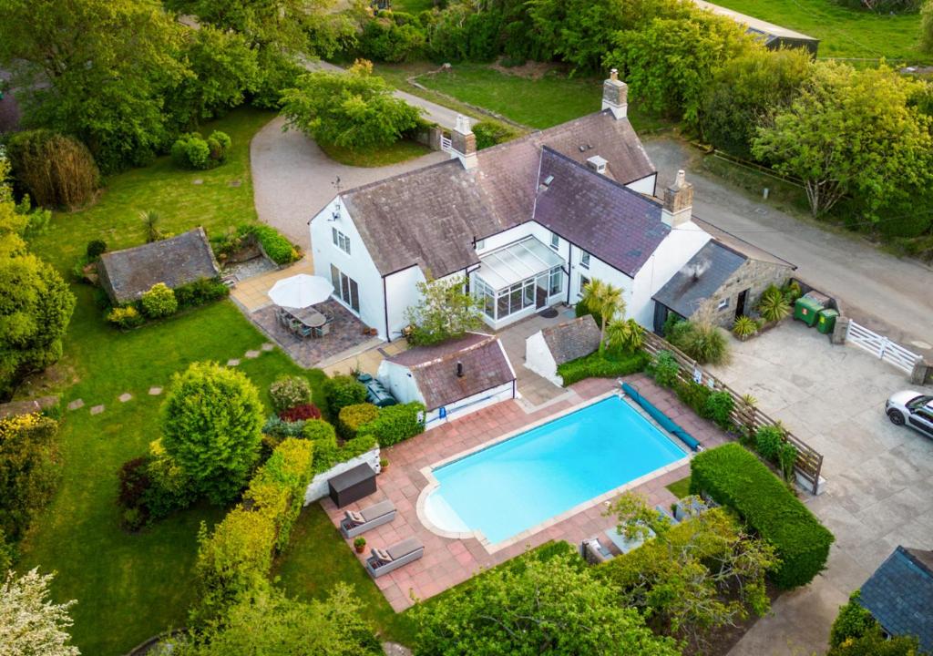 an aerial view of a house with a swimming pool at Plas Newydd in Rhiw