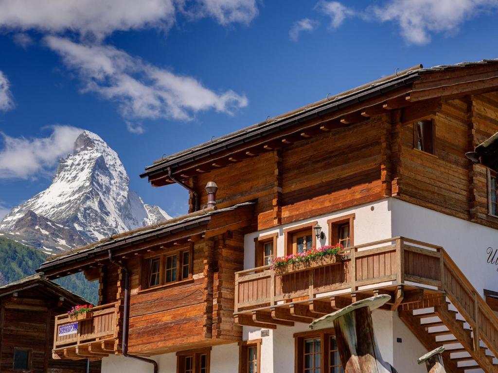 ein Holzhaus mit einem Berg im Hintergrund in der Unterkunft Chalet Ulysse in Zermatt