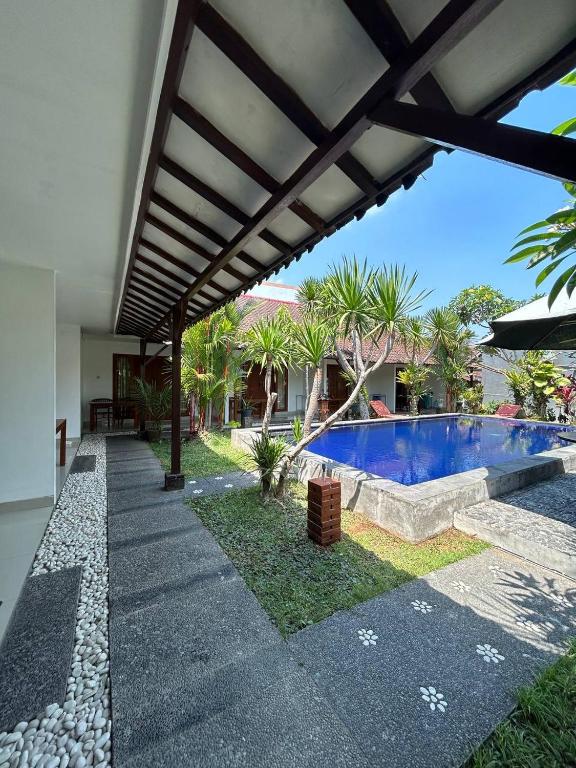 an external view of a house with a swimming pool at Pererenan nengah guest house canggu in Canggu