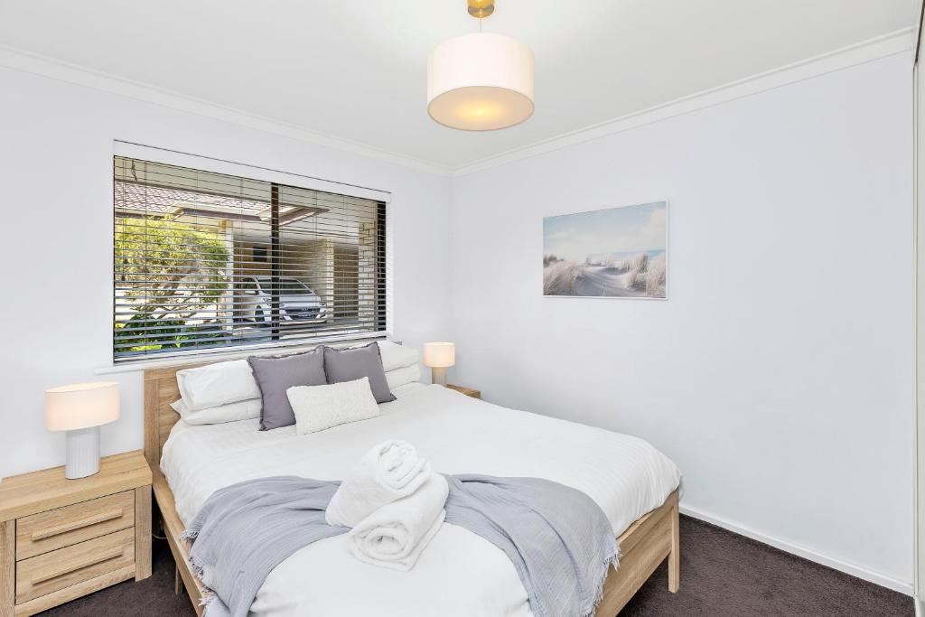 a bedroom with two beds and a window at Coastal convenience! Walk to the shops & cafes... in Perth
