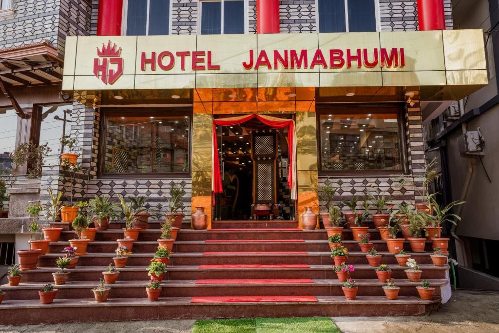 a hotel with potted plants in front of a building at Hotel Janmabhumi in Pashupatināth